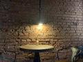 Old vintage loft brick wall lamp and table