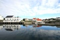 Old Lofts mirroring in Henningsvaer's harbour Royalty Free Stock Photo