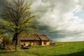 An old log cabin and an old cart. Vintage retro view in the countryside. Ukrainian village.