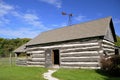 Old log cabin with wind vane Royalty Free Stock Photo