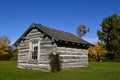 Old log cabin and windmill Royalty Free Stock Photo