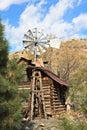 An old log cabin and windmill in the forest. Jerome, Arizona. Royalty Free Stock Photo