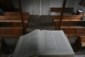 Old log church interior in Wisconsin bible close up with blurred pew background Royalty Free Stock Photo