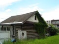 Old log home againist the apartments