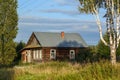 Old log house with a courtyard overgrown with grass. Village of Visim, Sverdlovsk region, Russia Royalty Free Stock Photo