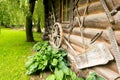 Old log house with wheel and trough and saw Royalty Free Stock Photo