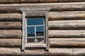 Old log house wood wall with window tilted on one side Royalty Free Stock Photo