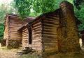 Old log pioneer home with a rock fireplace. Royalty Free Stock Photo