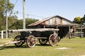 Old logging wagon and shed. Royalty Free Stock Photo