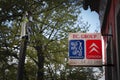 Old logos of Peugeot and Citroen logo on an sign of a car dealership of the brand.