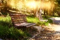 Old lonely bench in the quiet park at sunset light Royalty Free Stock Photo