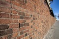 Old long brick wall in diminishing perspective Royalty Free Stock Photo