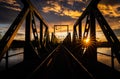 Old long bridge over the river in the countryside, scenic sunset cloudscape on the background Royalty Free Stock Photo