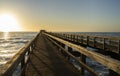 Old long wooden jetty at sunset Royalty Free Stock Photo