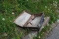Old suitcase lying on the lawn Royalty Free Stock Photo