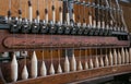 Old loom, spinning machine, rows of white and colored cotton threads Royalty Free Stock Photo
