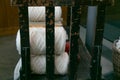 Old loom, spinning machine, rows of white and colored cotton threads Royalty Free Stock Photo