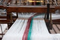 Old loom, spinning machine, rows of white and colored cotton threads Royalty Free Stock Photo