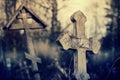 Old lop-sided sepulchral crosses on the thrown graves at the cemetery