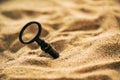 Old lost key in the sand