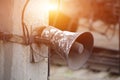 Old loudspeaker hanging pole in sunset rays Royalty Free Stock Photo