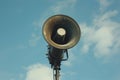 Old loudspeaker pointing at the sky on cloudy background Royalty Free Stock Photo