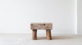 Old low Chinese oak stool in an empty room with white wall and floor. Rustic handmade furniture. Generative AI