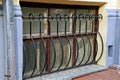 Old lower cellar window at the sidewalk behind the black grill Royalty Free Stock Photo