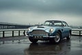 old luxury English vintage car parked outdoors on the pier of a marina on a cloudy day Royalty Free Stock Photo