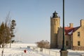 Old Mackinac Point Lighthouse and Mackinac Bridge on frozen Straits of Mackinac, Mackinac City, Michigan in winter Royalty Free Stock Photo