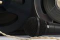 Old magnetic tape cassettes and a microphone, front view, close-up Royalty Free Stock Photo