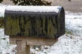 old mailbox covered in thin layer of snow