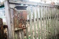 An old mailbox on the fence. Vintage rusty mailbox on a wooden fence Royalty Free Stock Photo