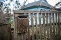 An old mailbox on the fence. Vintage rusty mailbox on a wooden fence near Royalty Free Stock Photo