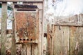 An old mailbox on the fence. Vintage rusty mailbox on a wooden fence Royalty Free Stock Photo