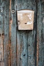 An old mailbox on green painted wooden door Royalty Free Stock Photo