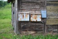 Old mailboxes fixed on a wooden shed on the outskirts of the village. Tukums region. Latvia. May 31, 2019