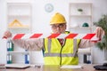 Old male architect holding caution tape Royalty Free Stock Photo
