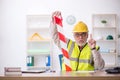 Old male architect holding caution tape Royalty Free Stock Photo