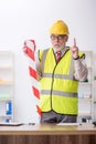 Old male architect holding caution tape Royalty Free Stock Photo
