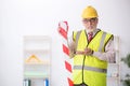 Old male architect holding caution tape Royalty Free Stock Photo