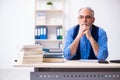 Old male author writing books Royalty Free Stock Photo