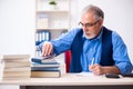 Old male author writing books Royalty Free Stock Photo