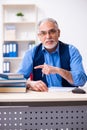 Old male author writing books Royalty Free Stock Photo