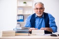 Old male author writing books Royalty Free Stock Photo