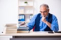 Old male author writing books Royalty Free Stock Photo