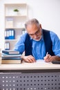 Old male author writing books Royalty Free Stock Photo