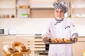 The old male baker working in the kitchen Royalty Free Stock Photo