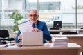 Old male boss employee working in the office Royalty Free Stock Photo