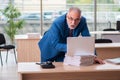 Old male boss employee working in the office Royalty Free Stock Photo
